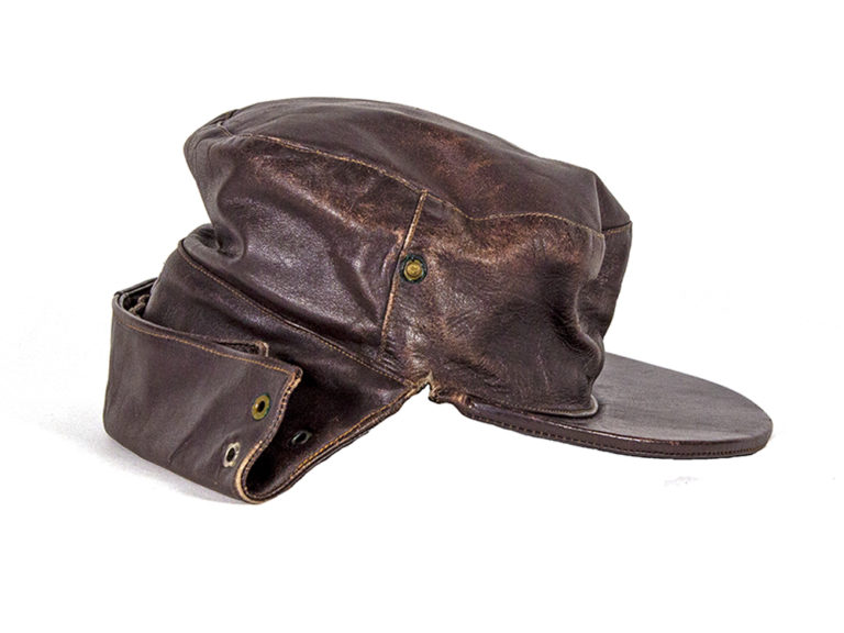 Leather cap with adjustable flap around the back of the head to be worn while riding a motorcycle