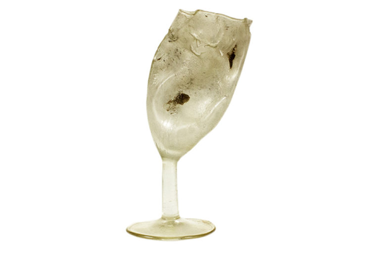 A wine glass which has melted out of shape
