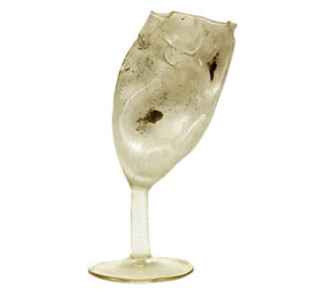 A wine glass which has melted out of shape